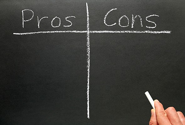 Pros and cons written on a black board