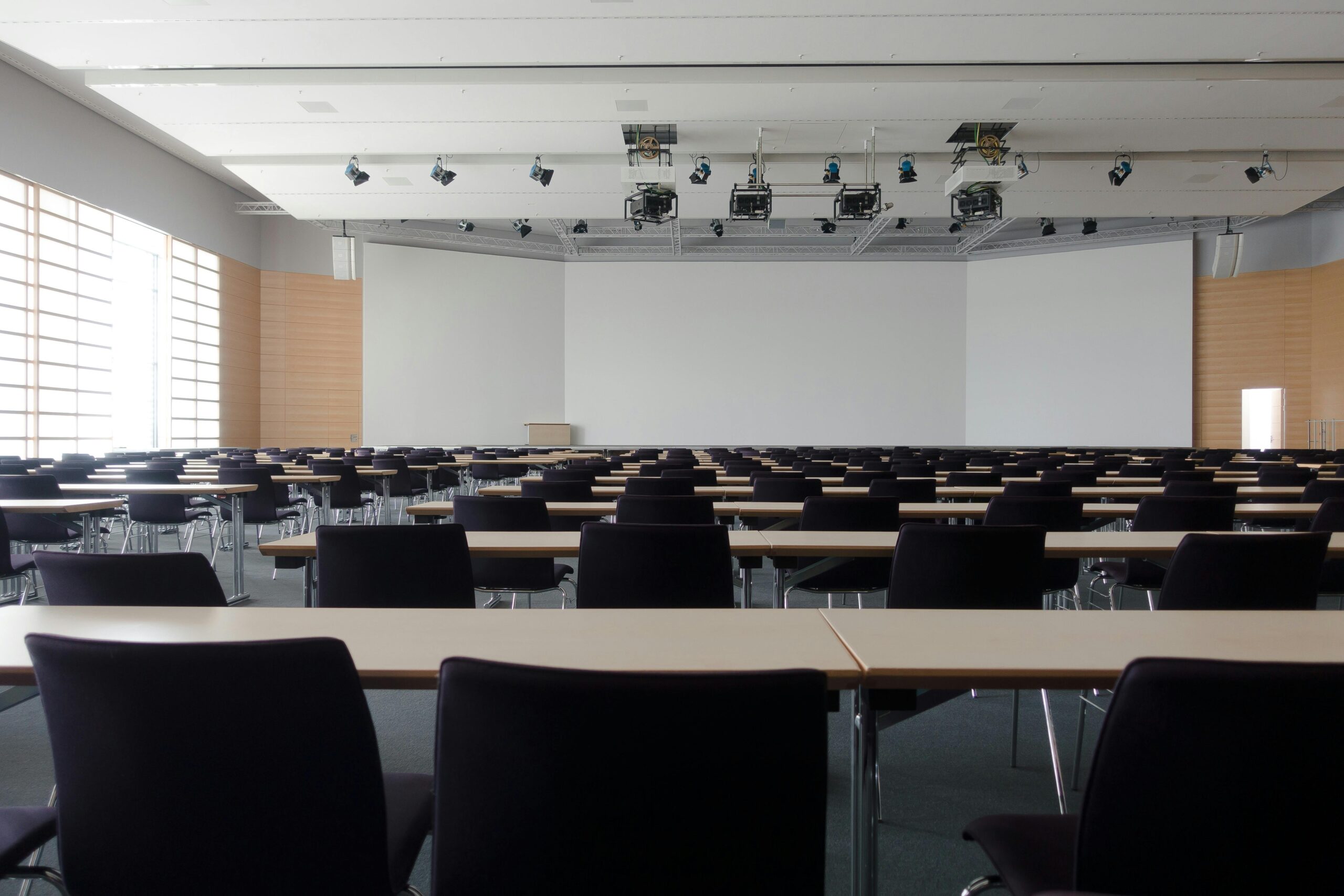 rows of chairs and long tables facing lecture board