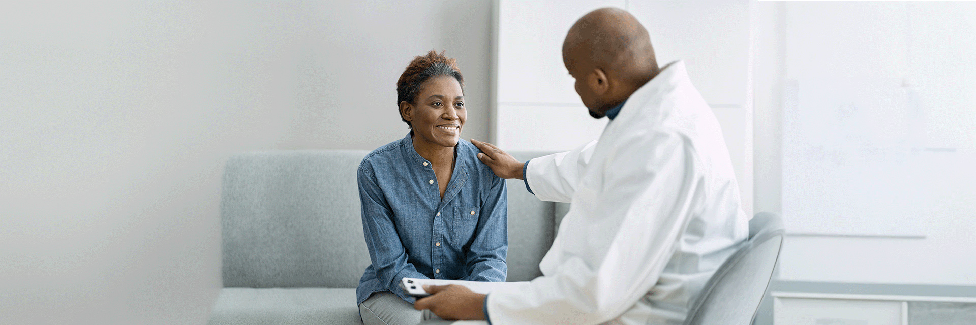 Medical students consulting with a physician mentor in a clinical setting, representing medical school admissions guidance