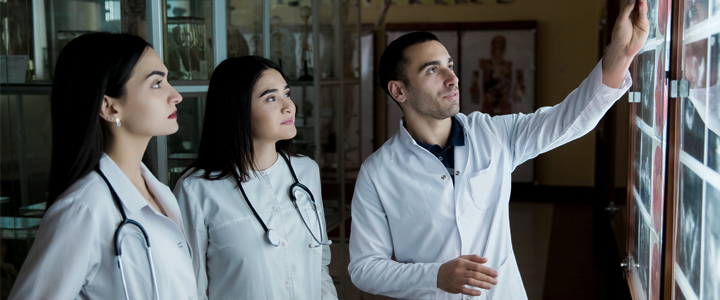 Medical students examining medical scans and diagnostic results in a clinical setting