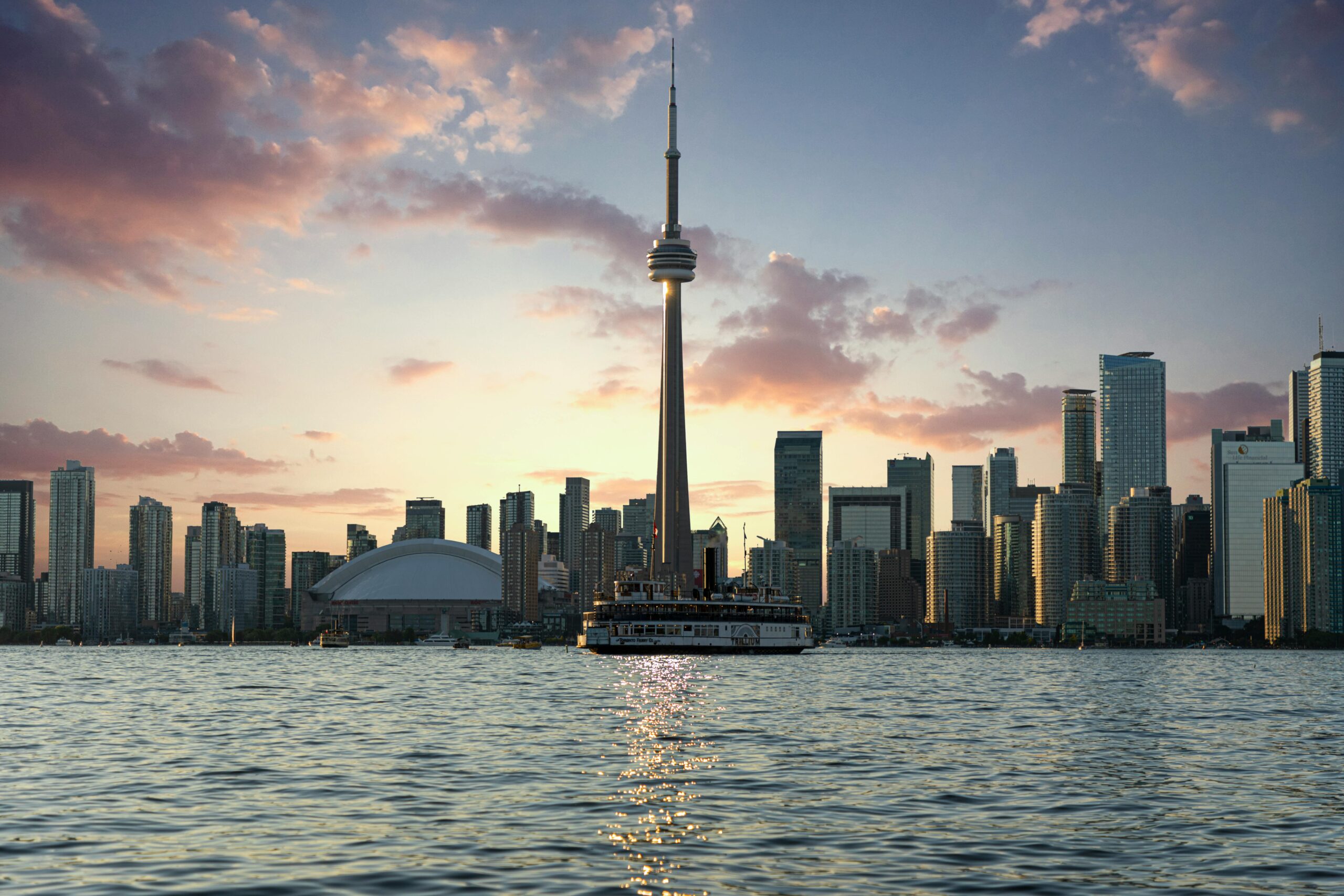 Large ferry on the water in front of the Toronto skyline
