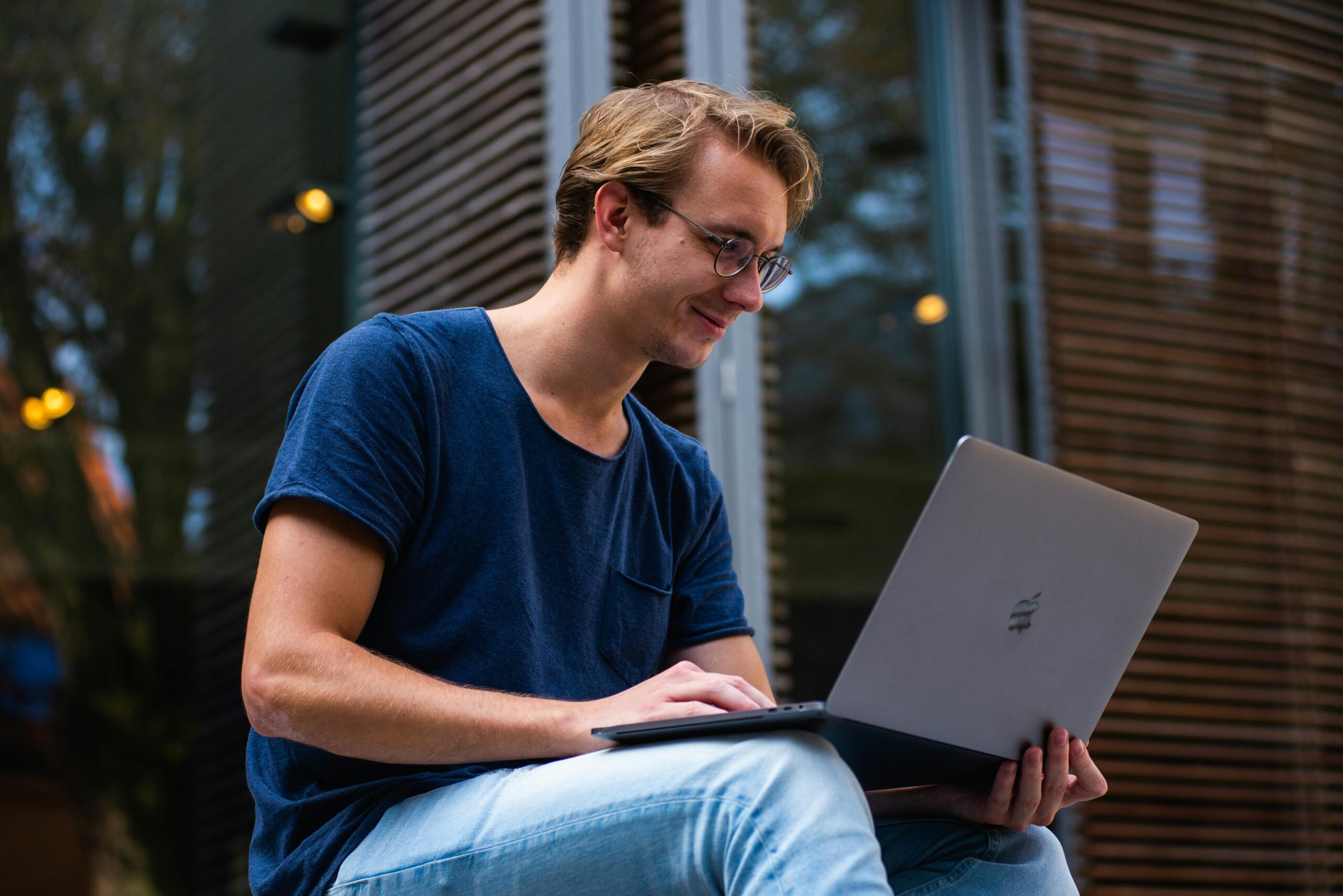 College student sitting outside with laptop
