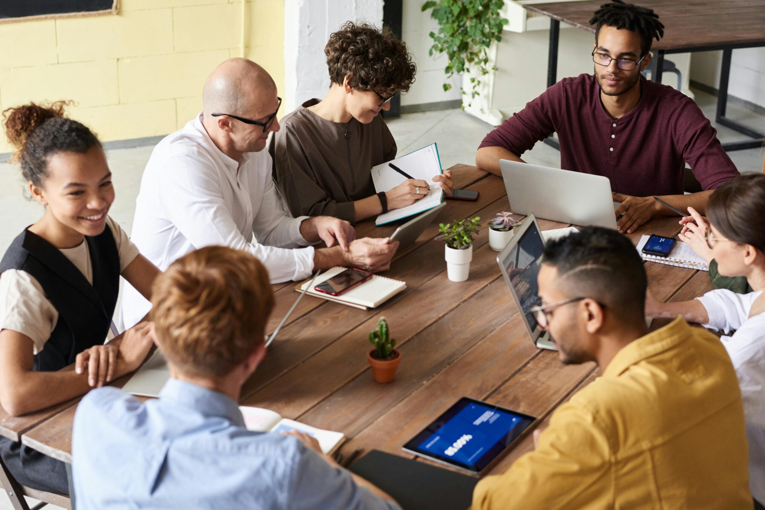 Group of people around conference table wearing business casual attire