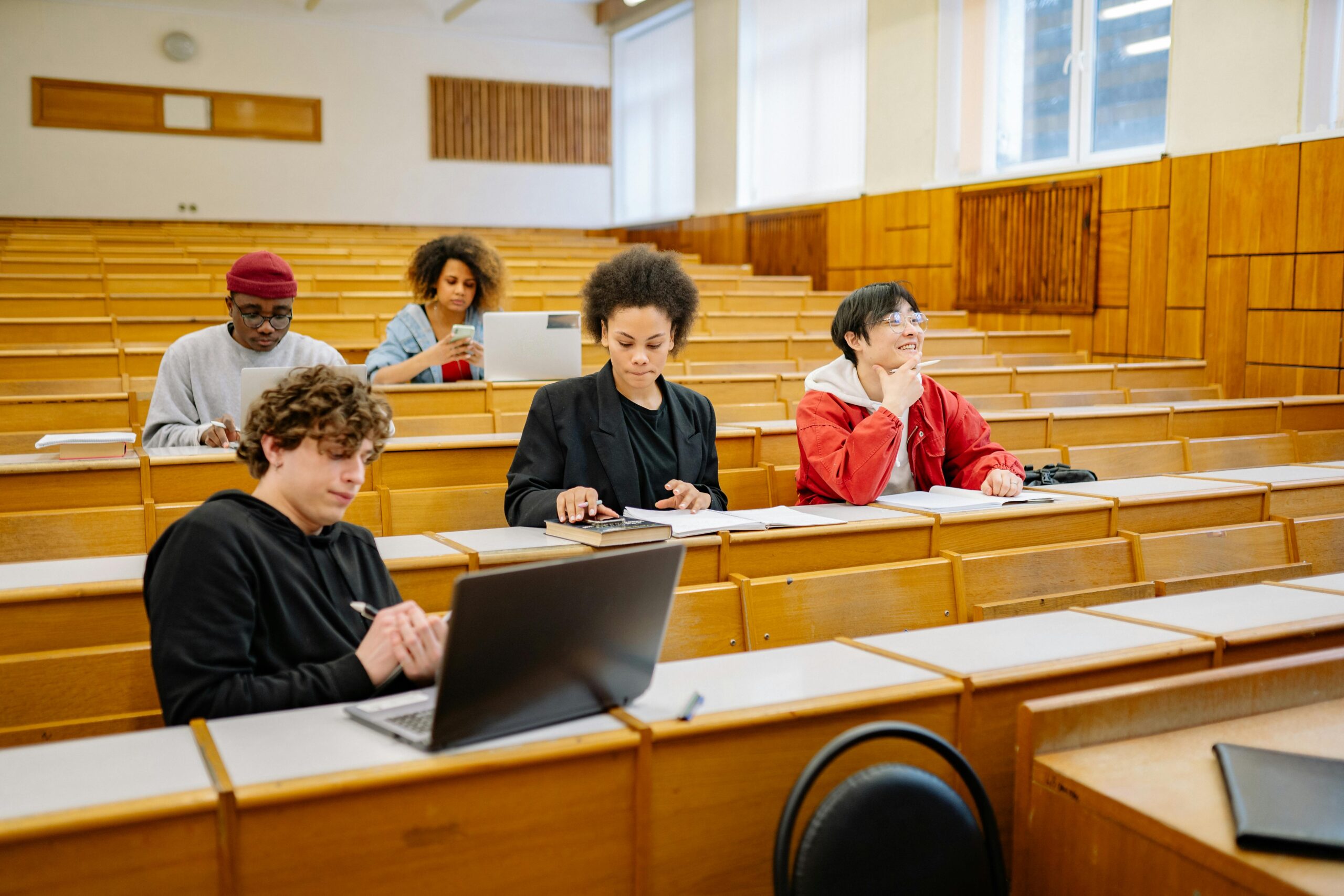5 students studying in large lecture hall