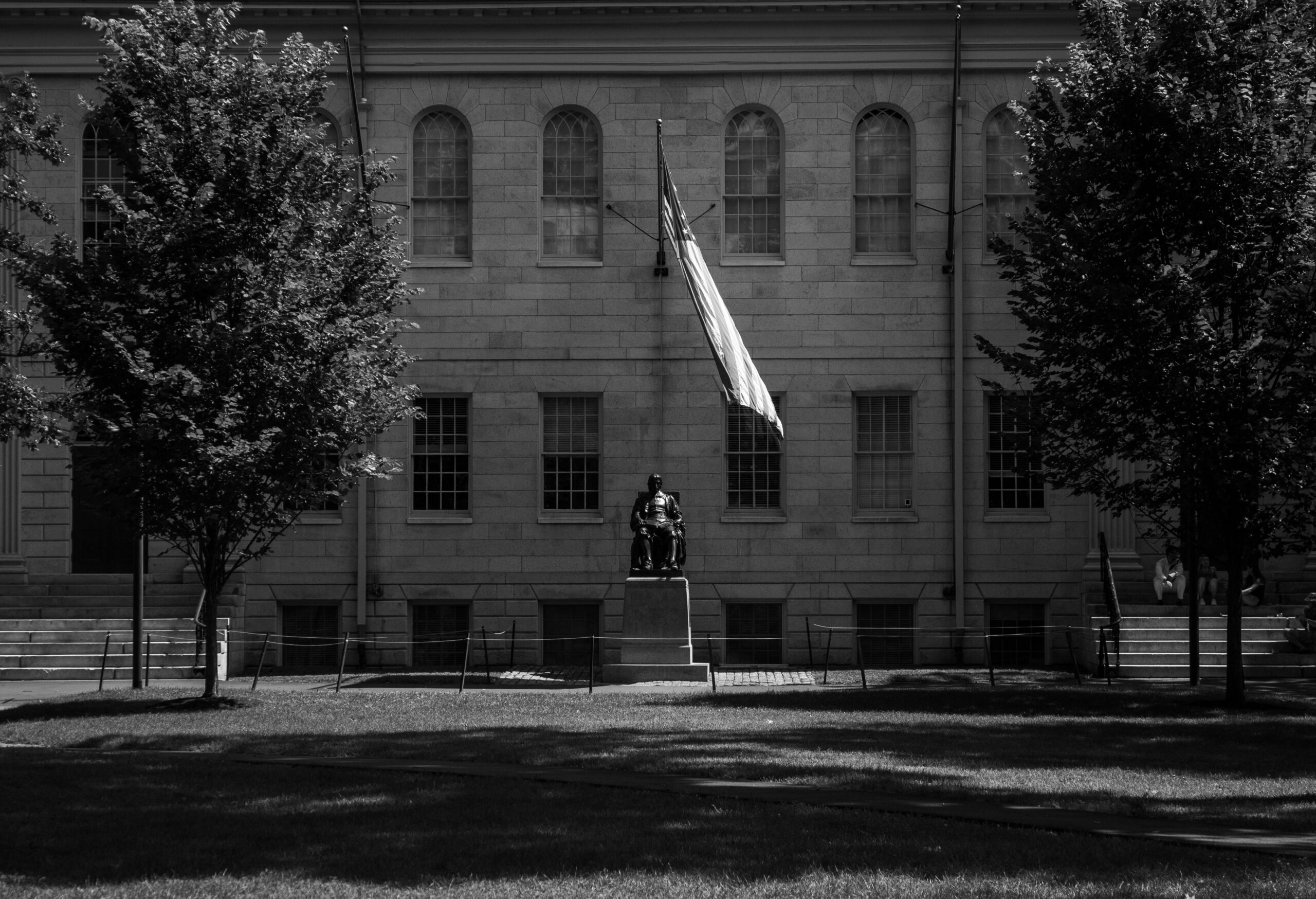 Grayscale Photo of a Concrete Statue