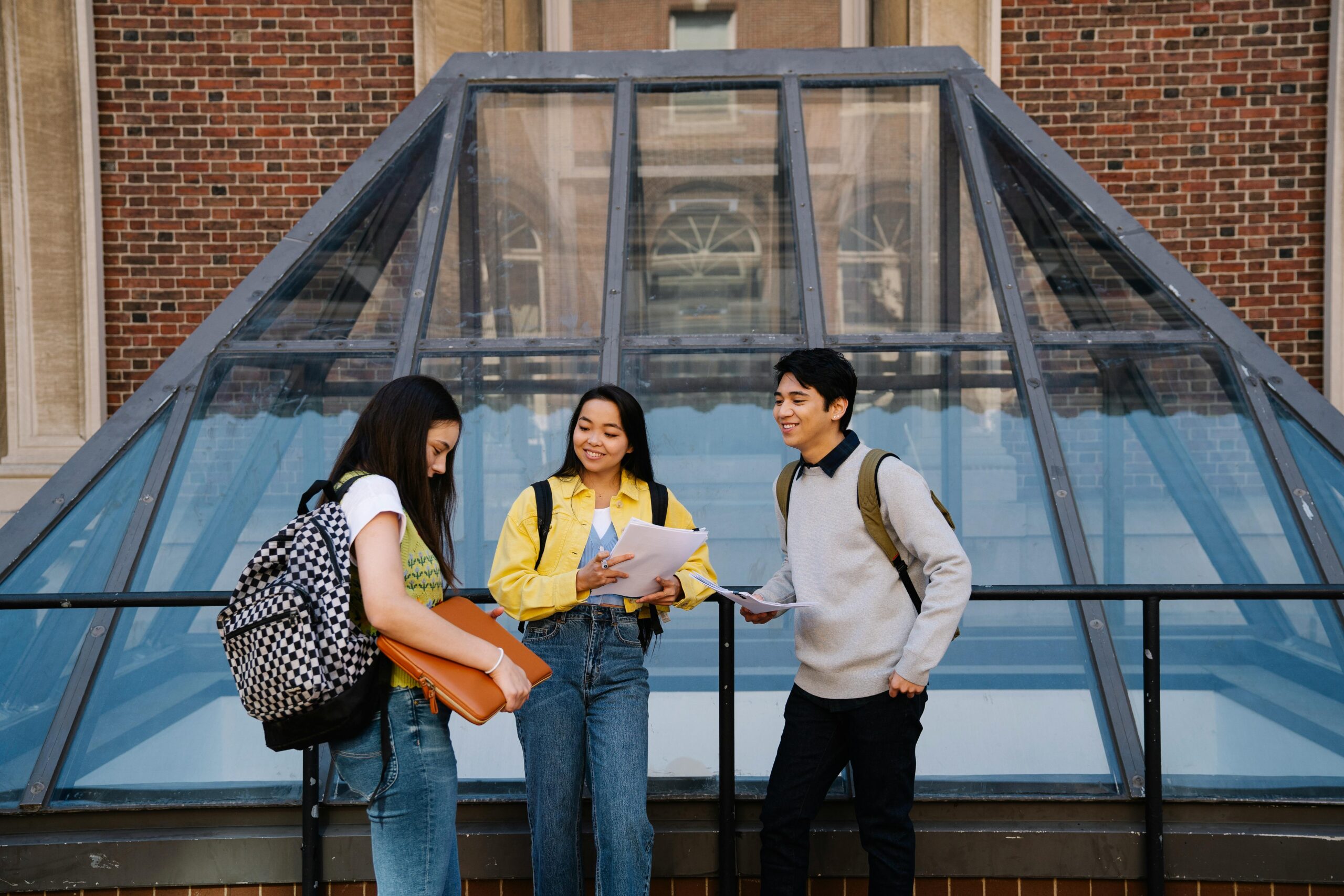 Three students standing and talking together