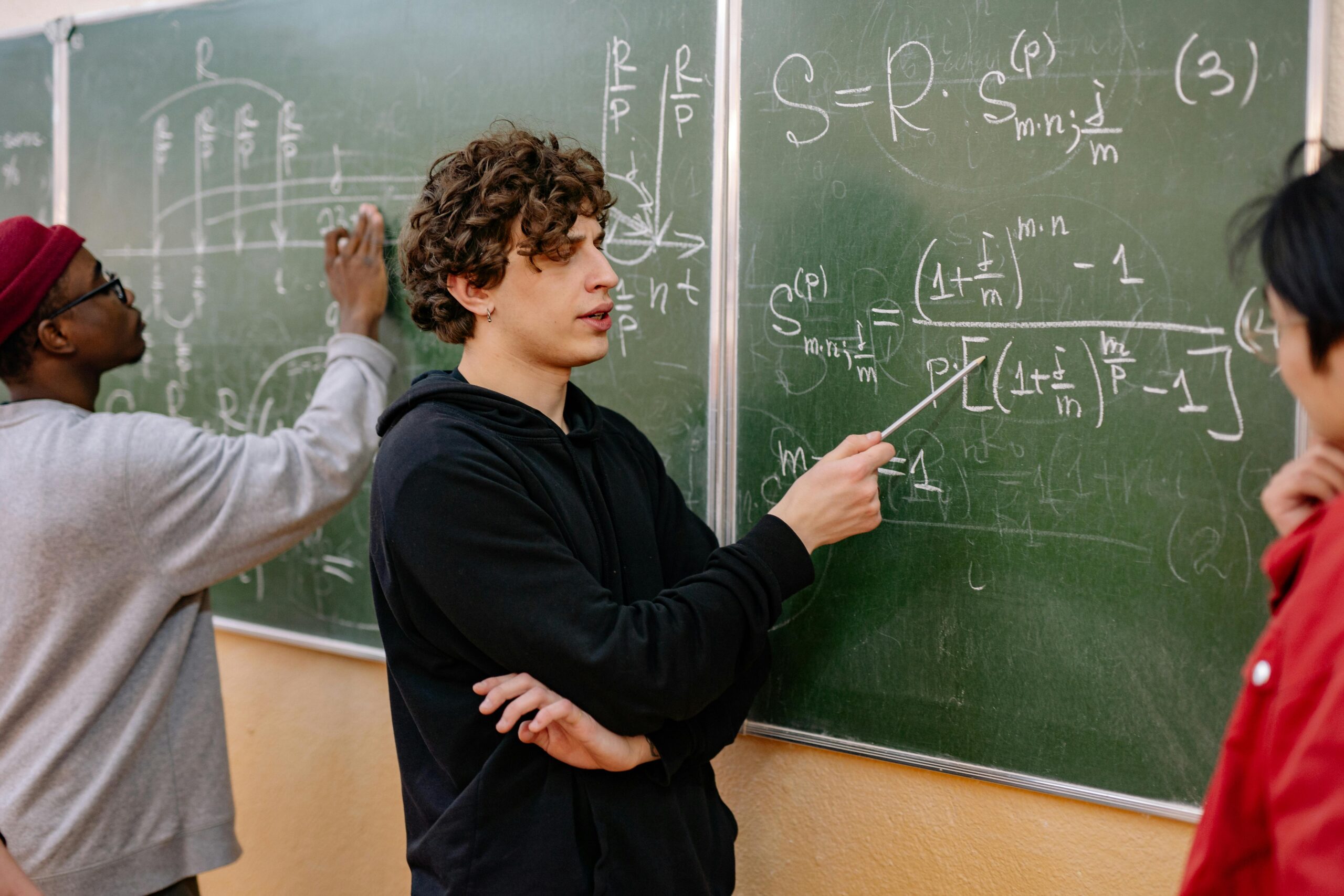 Men Standing in Front of a Blackboard