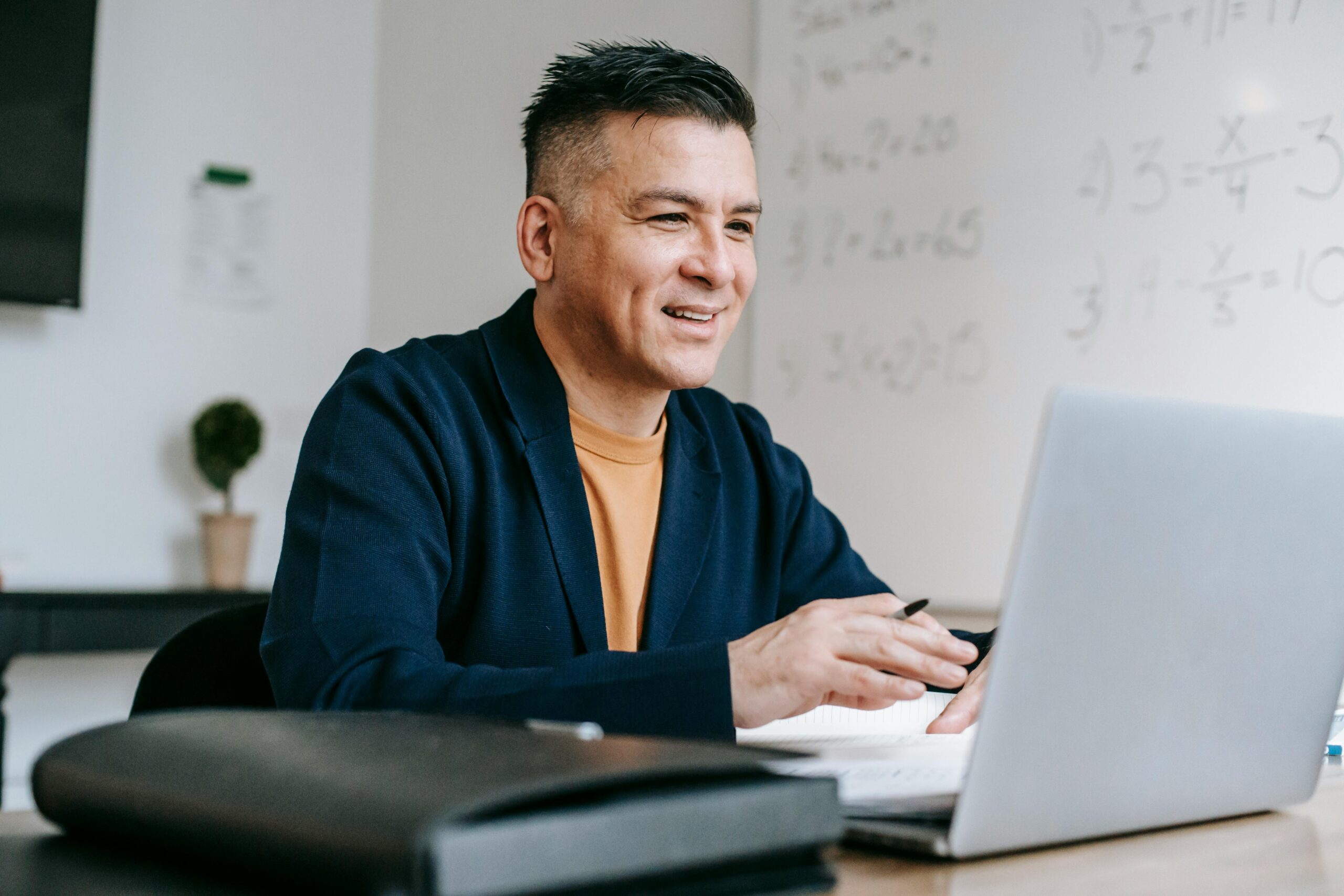Photo Of Man Looking Happily On His Laptop