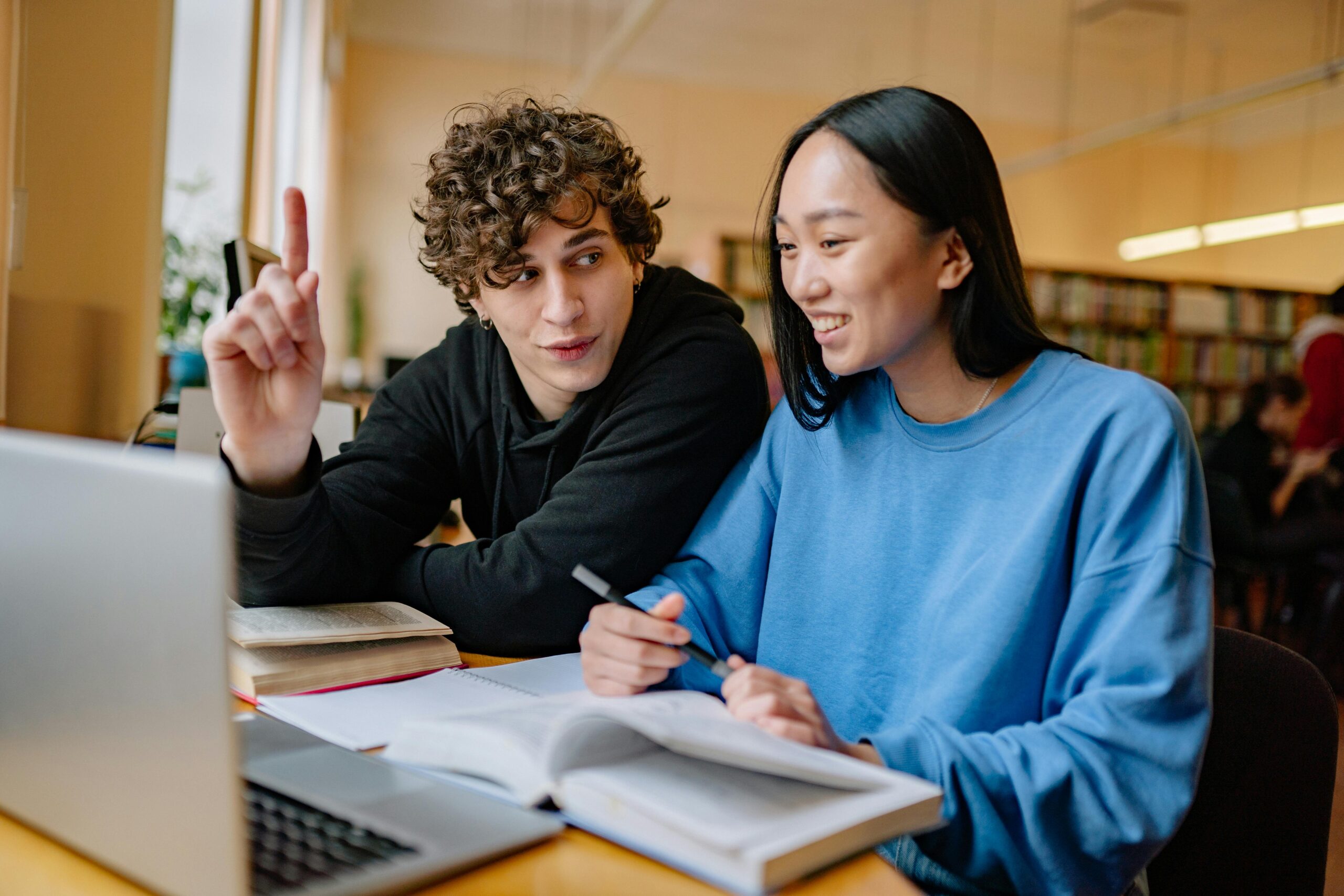 A Man and a Woman Sitting in a Library