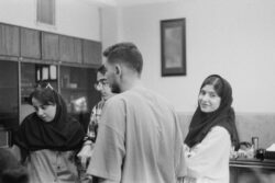 a group of people standing around each other